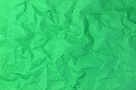 Green crumpled paper background for art designの写真素材