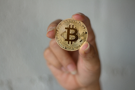 BITCOIN Gold Digital Currency cryptocurrency market.digital Holding money in handの写真素材