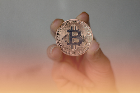 Bronze, BITCOIN, Digital Currency cryptocurrency market.digital Holding money in handの写真素材