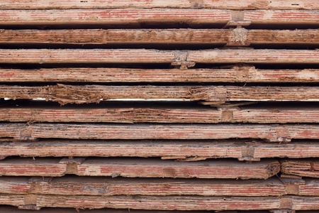 Stacked used red form boards with chips and bracketsの写真素材