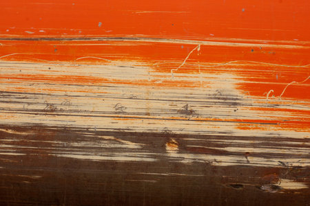 orange and tan scraping on construction equipmentの写真素材