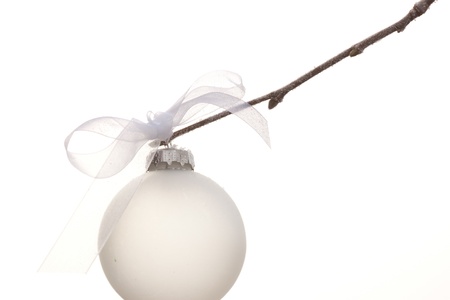 white christmas ornament hanging on a christmas treeの写真素材