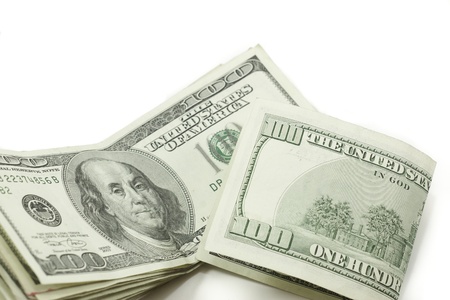a stack of 100 dollar bills with one folded showing the backの写真素材