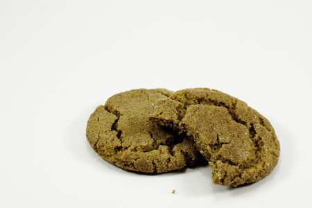 two ginger snap cookies with biteの写真素材
