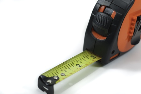 extended orange tape measure isolated on white backgroundの写真素材