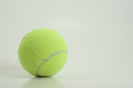 bright green new tennis ball isolated on white backgroundの写真素材