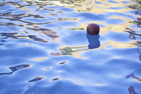 red flame ball floating in pool in summer timeの写真素材
