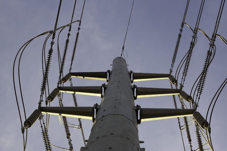 large high voltage power lines on pole viewed from directly beneathの写真素材
