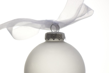 white christmas ornament hanging on a christmas treeの写真素材