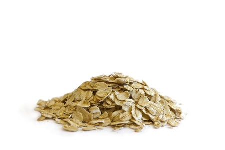 Side view of a pile of raw organic oat on white background の写真素材