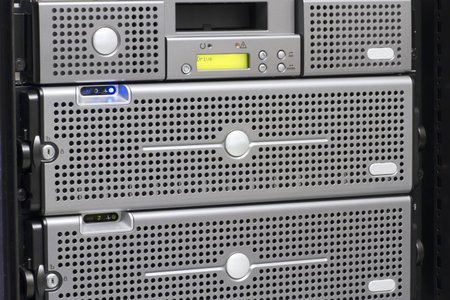 A backup tape robot and a disk cabinet   SAN mounted in a rack  Shot in a data center 