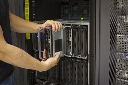 It engineer   consultant install   inserts or removes a blade server in a blade chassis in a rack ...