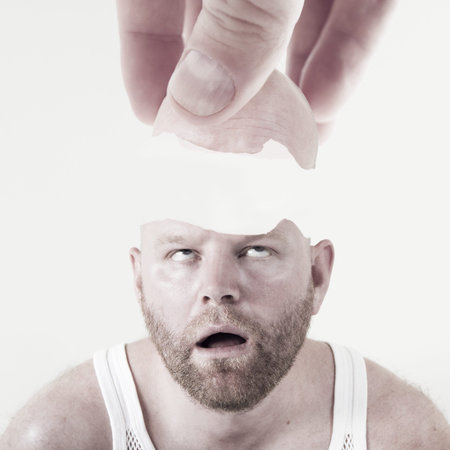 Hand lifting off the top of the head  Cracked egg like head 