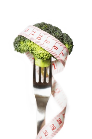 A diet   dieting concept photo  Broccoli on a fork with a measure tape on の写真素材