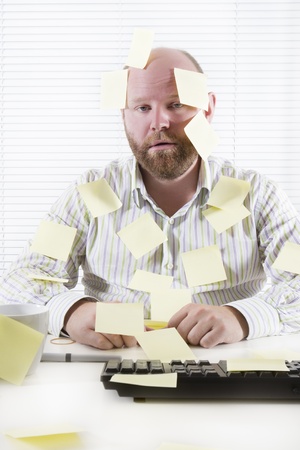 Exhausted and tired office worker in the office  To much work and no motivation  Place your own text on the notes の写真素材