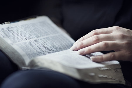 A close-up of a christian woman reading the bible  Very shallow depth of fields 