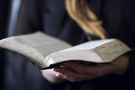 A close-up of a christian woman reading the bible  Very shallow depth of fields の写真素材