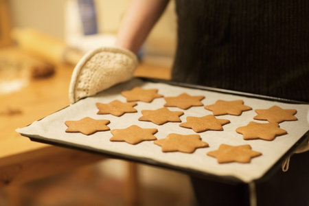 Woman baking ginger bread stars for Christmas  Natural Colors  Real lifeの写真素材