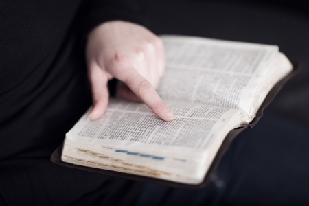 A close-up of a christian woman reading and study in the bible  Very shallow depth of fields  Toned の写真素材