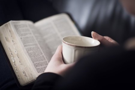 A close-up of a christian woman reading and study in the bible  Very shallow depth of fields  Toned 