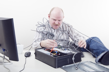 Office worker   businessman in cables has computer problems の写真素材