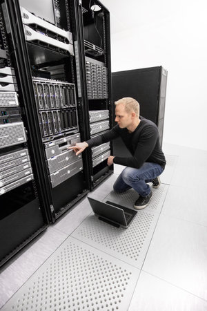 It engineer or consultant working with backup server. Shot in data center.
