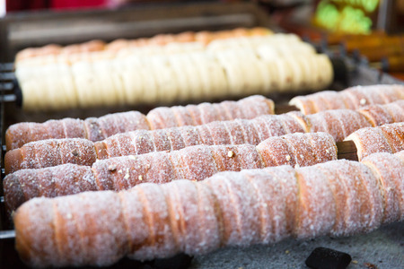 Rolled Pastries on a barbecue in Prague and Slovakia. Street food called trdelnik.の写真素材