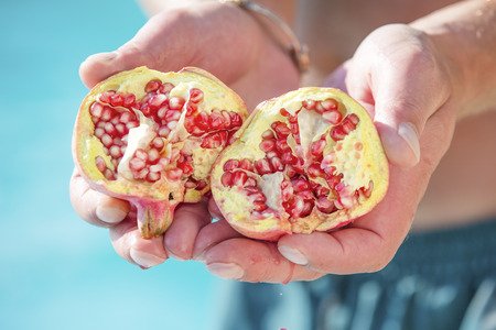 Divided organic pomegranate from the treeの写真素材