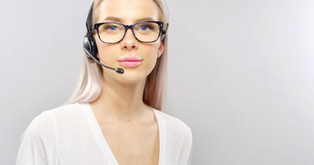 Close-up of a smiling customer service or support representative with headset