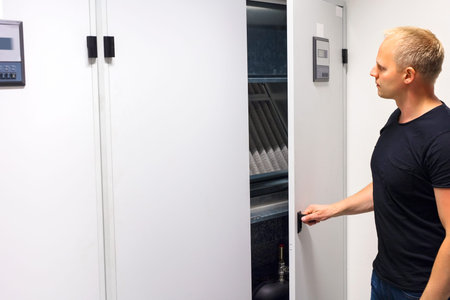 Technician Opening Air Conditioner Cabinet In Datacenter