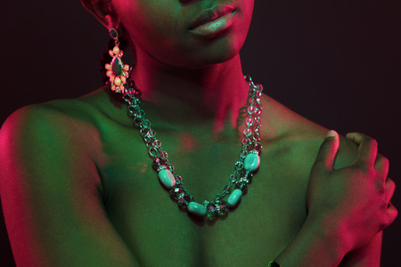Colorful and creative portrait of african womans upper body with dark skinの写真素材