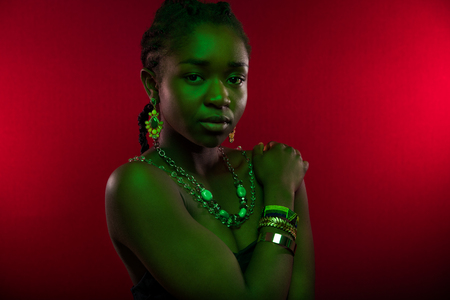 Sensuous Woman Wearing Jewelry Over Red Backgroundの写真素材