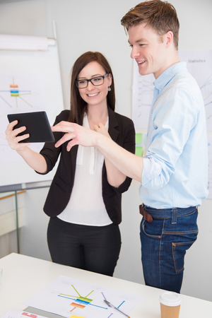 Businessman And Colleague Using Digital Tablet At Deskの写真素材