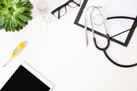 Digital Tablet By Thermometer And Medical Instruments On White Tの写真素材