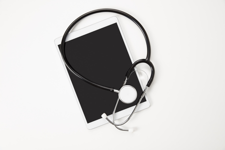 Digital Tablet And Stethoscope On White Tableの写真素材