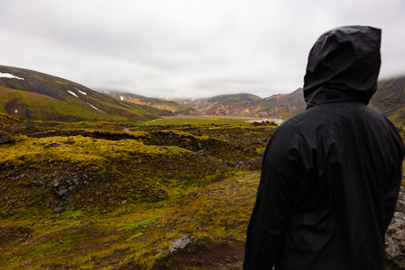 Female Hiker Standing On Rock While Enjoying Nature At Icelandの写真素材
