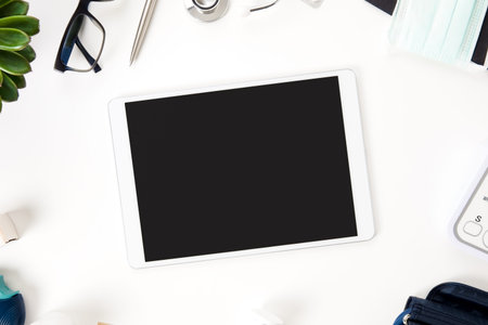 Tablet Computer With Blank Screen And Medical Equipment On Table