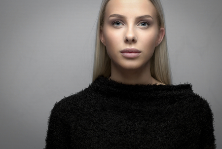 Portrait of a young blonde woman with fury jacketの写真素材