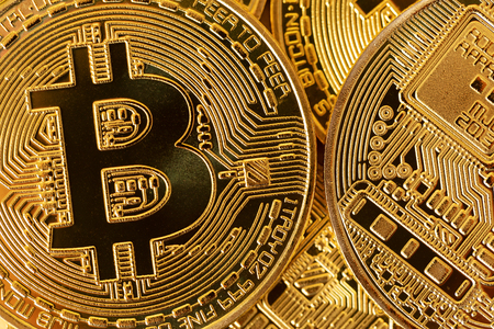 Top view closeup photo of gold bitcoins in a pileの写真素材