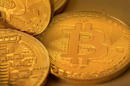 Top view closeup photo of many gold bitcoins
