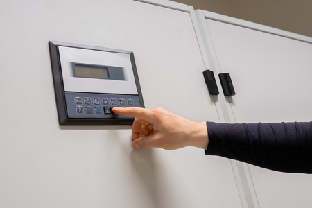 Professional Engineer Adjusting Air Conditioner In Datacenterの写真素材