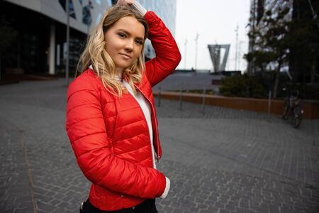 Portrait Of Beautiful Young Blonde Woman With Her Hand in the Hair In Cityの写真素材