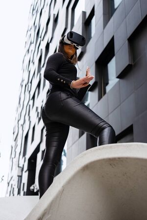 Excited Woman With Virtual Reality Glasses In Cityの写真素材