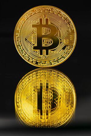 Gold Bitcoin With Reflection On Black Backgroundの写真素材