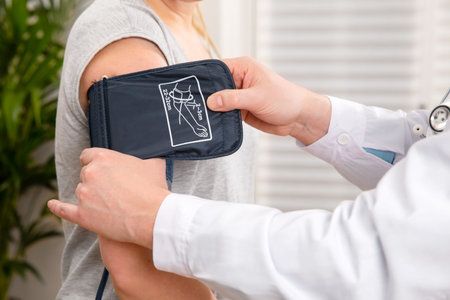 Doctor Checking Blood Pressure Of Patient In Hospital