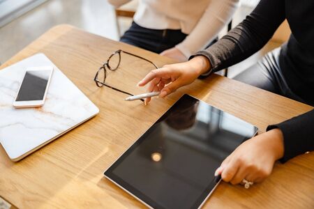 Top view of Professional Team Using Digital Tablet At Cafeの写真素材