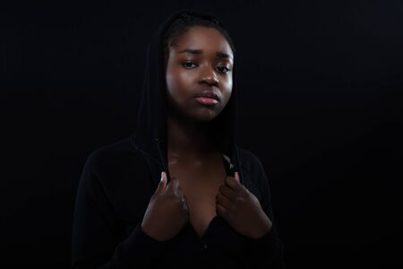 Confident woman with dark skin and cool attitude wearing hoodieの写真素材