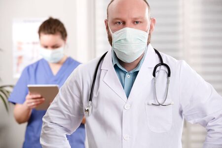 Confident Doctor And Nurse With Arms Crossed In Clinicの写真素材