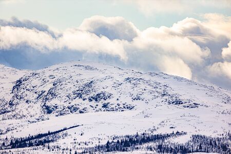 Idyllic shot of white snow covered mountain in Norway against skyの写真素材