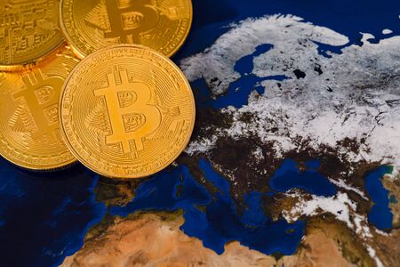 Golden Shiny Bitcoin Crypto Currency Coins On World Mapの写真素材